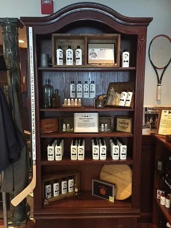 Wooden cabinet displaying Black Tie signature products